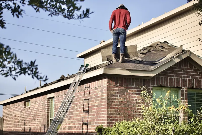 Professional roofer working on a residential roof in Far Hills